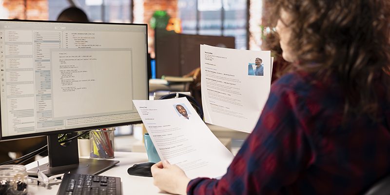 Startup HR worker identifying right candidates for job opening, reviewing resume